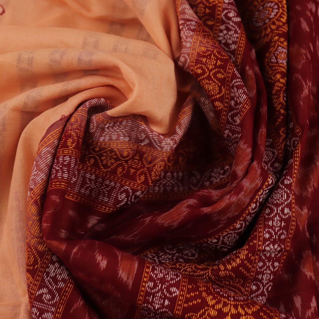 Full view of a cream cotton Bomkai saree with a maroon butta pattern.