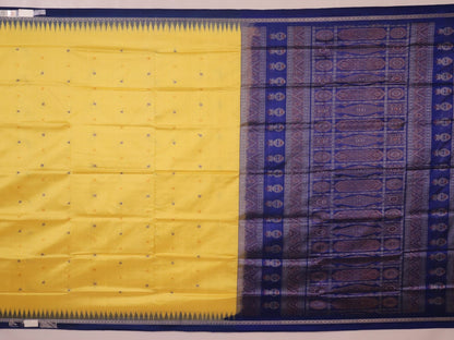 Textured close-up of yellow Bomkai silk saree fabric with blue butta pattern.