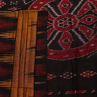 Brown and black plain Sambalpuri cotton saree styled, showcasing its elegant drape and subtle colors.