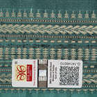 Close-up of green Sambalpuri silk fabric, showing its luxurious texture and fine handloom weave.