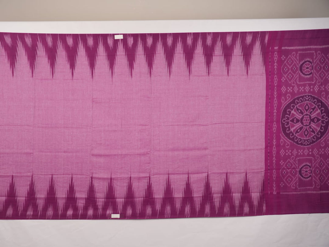 Model draped in a plain pink Sambalpuri cotton saree, styled to show the graceful fall and elegant border.