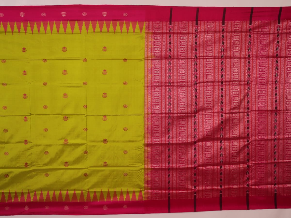 Close-up of green and magenta Bomkai silk saree fabric texture, highlighting intricate weave and butta pattern.