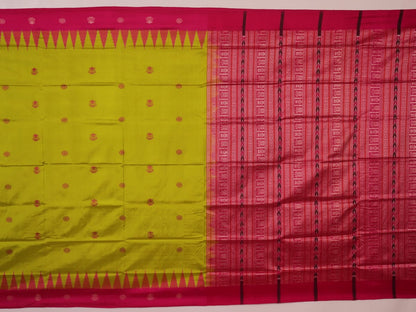 Close-up of green and magenta Bomkai silk saree fabric texture, highlighting intricate weave and butta pattern.