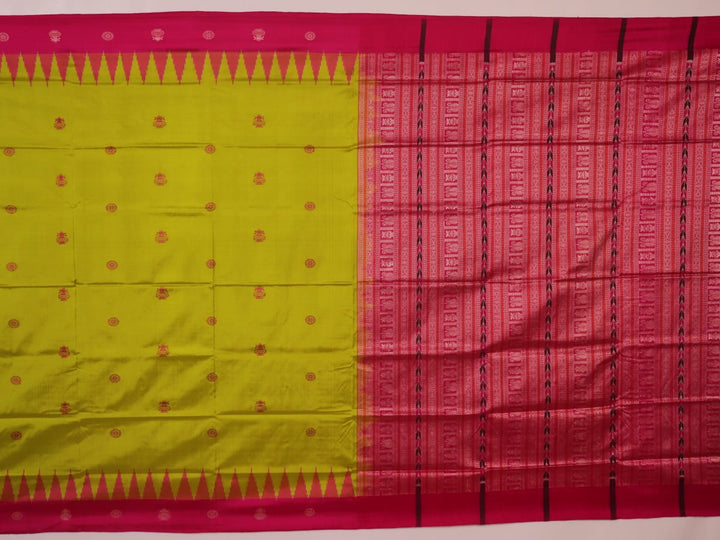 Close-up of green and magenta Bomkai silk saree fabric texture, highlighting intricate weave and butta pattern.