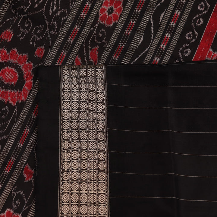 Close-up of white silk handloom saree with black Sambalpuri motifs