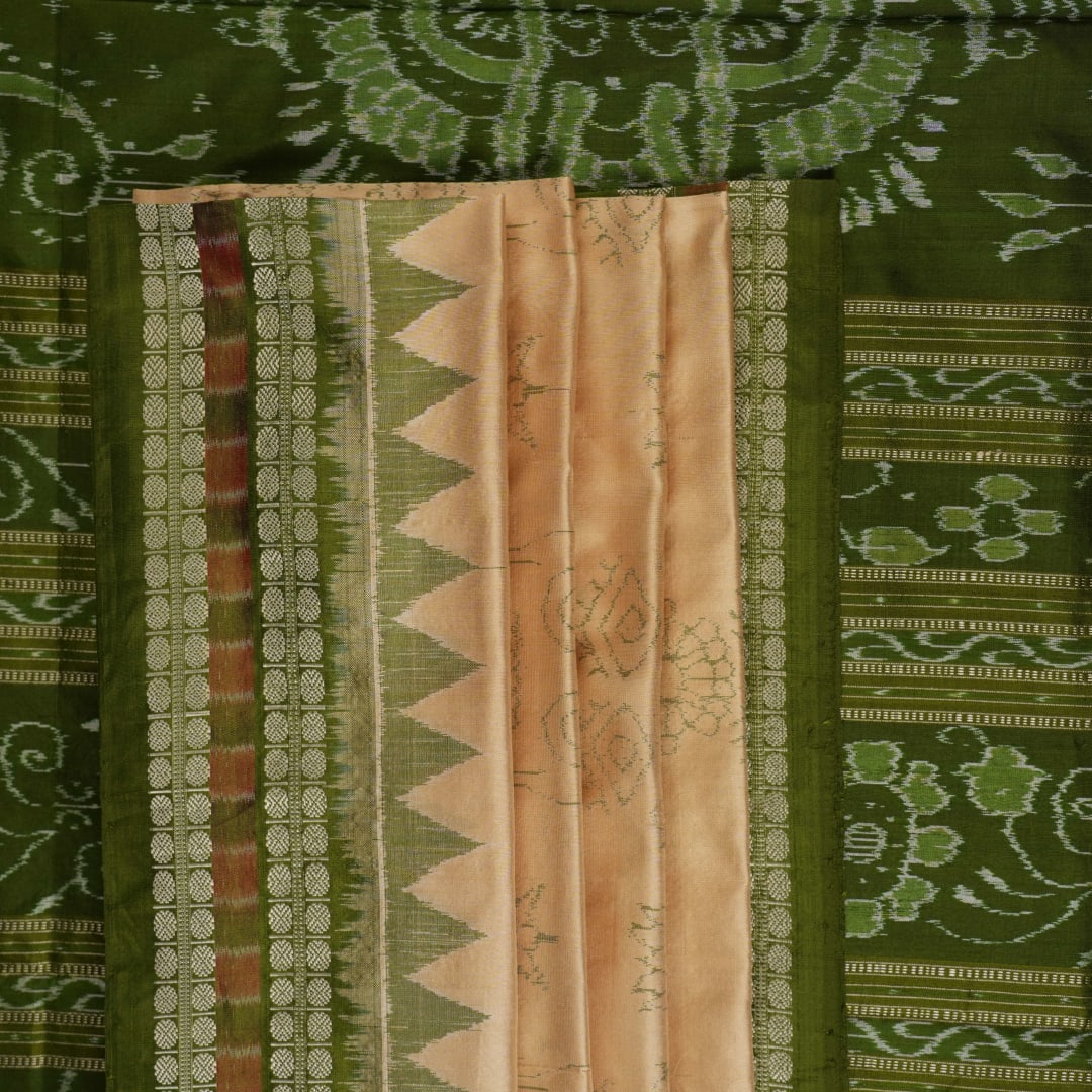 Extreme close-up of cream Sambalpuri silk saree showing exquisite handloom weave texture.