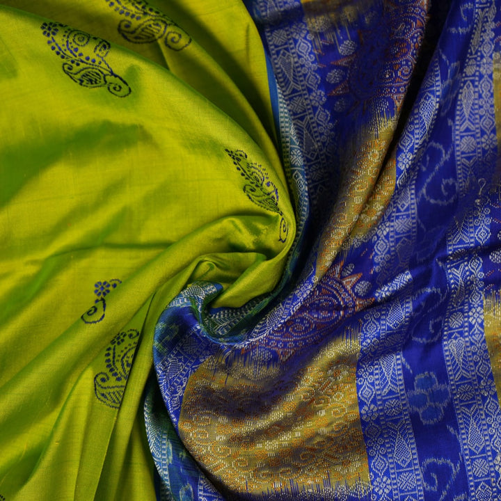 Detailed close-up of the exquisite green Bomkai Silk Saree fabric, highlighting its luxurious silk weave.