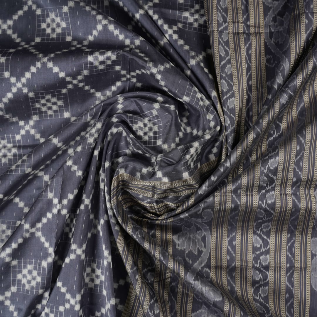 Close-up of the soft, luxurious grey Sambalpuri silk fabric texture with subtle weave details.