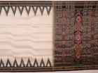 White Khandua silk saree draped, showcasing its plain body and simple elegance.