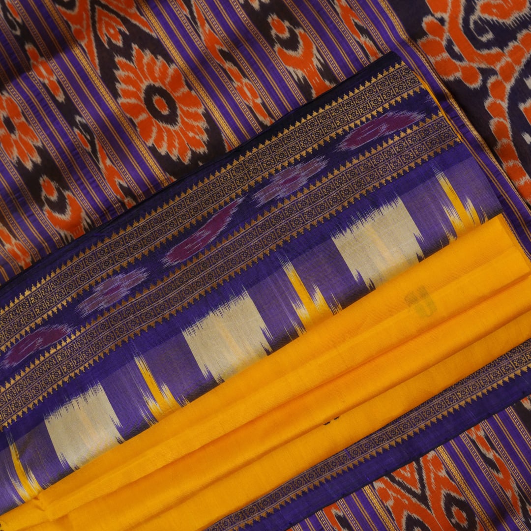 Full styling view of a model draped in a vibrant yellow and blue handloom Khandua silk saree with butta work.