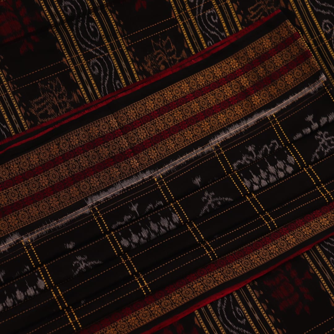 Full view of a black and black cotton Sambalpuri saree with intricate motif patterns.