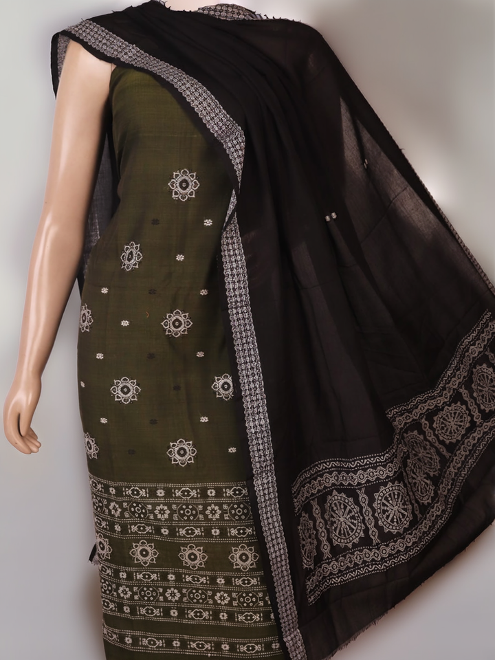 Detail of coordinating black Bomkai cotton blouse piece for green dress material.