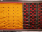 Close-up showcasing the smooth, golden-yellow silk texture of the Bomkai saree, adorned with intricate black butta patterns.