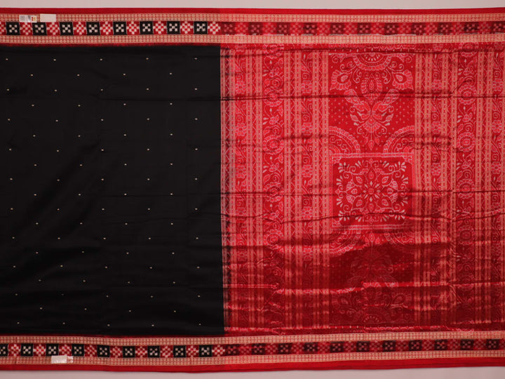 Close-up of black and red silk saree fabric with intricate Sambalpuri motifs