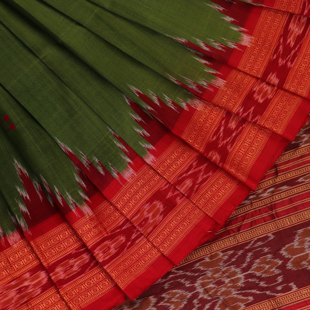 Green Khandua silk saree draped, showcasing its butta pattern and red accents.