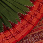 Green Khandua silk saree draped, showcasing its butta pattern and red accents.