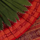 Green Khandua silk saree draped, showcasing its butta pattern and red accents.