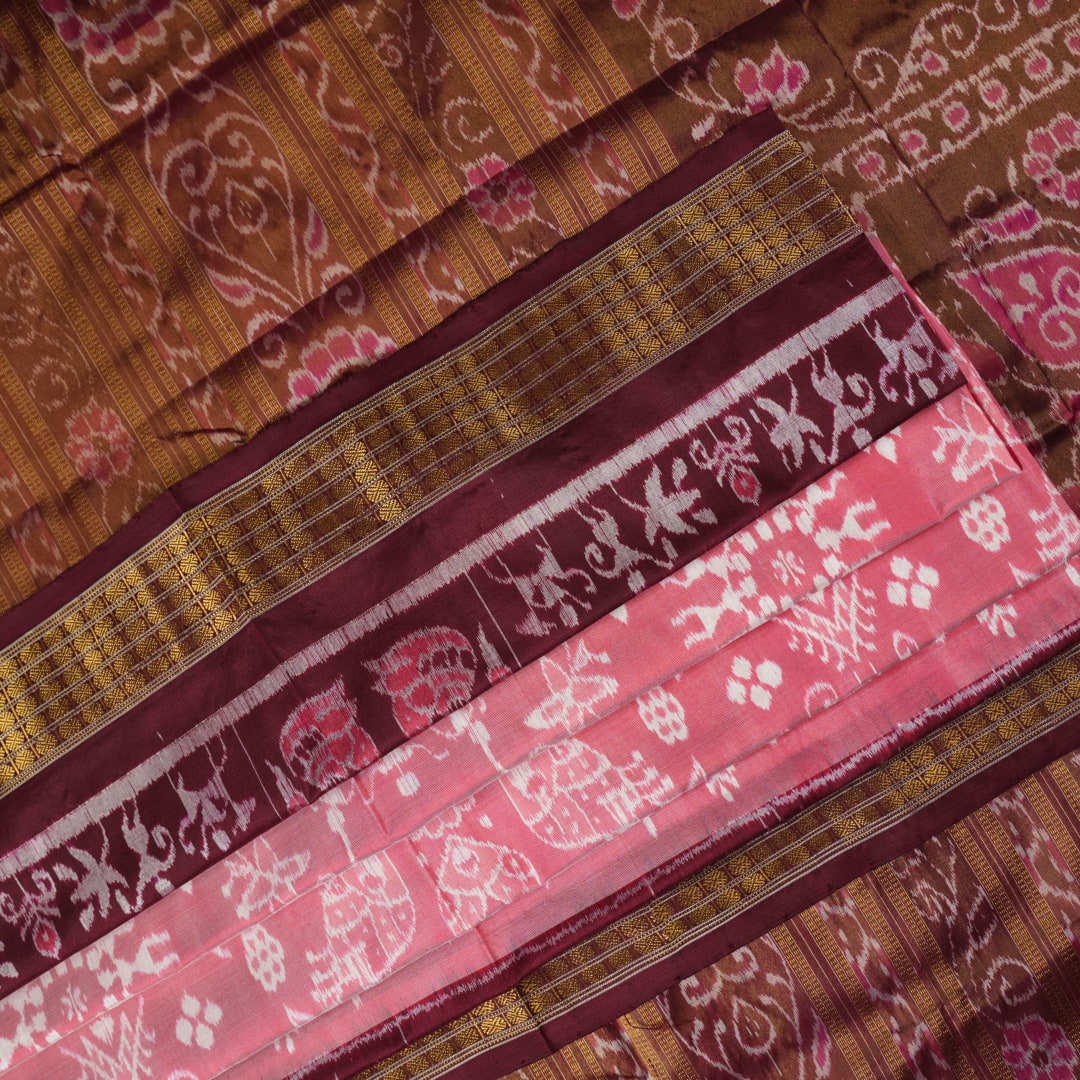 Close-up of luxurious silk fabric texture and intricate weave details of the multi-color Sambalpuri saree.