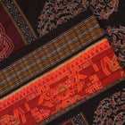 Full flat layout of the orange and black Sambalpuri cotton saree showing the body, border, and pallu