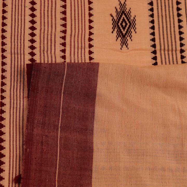 Full view of a cream-colored handloom Kotpad cotton saree with maroon butta patterns