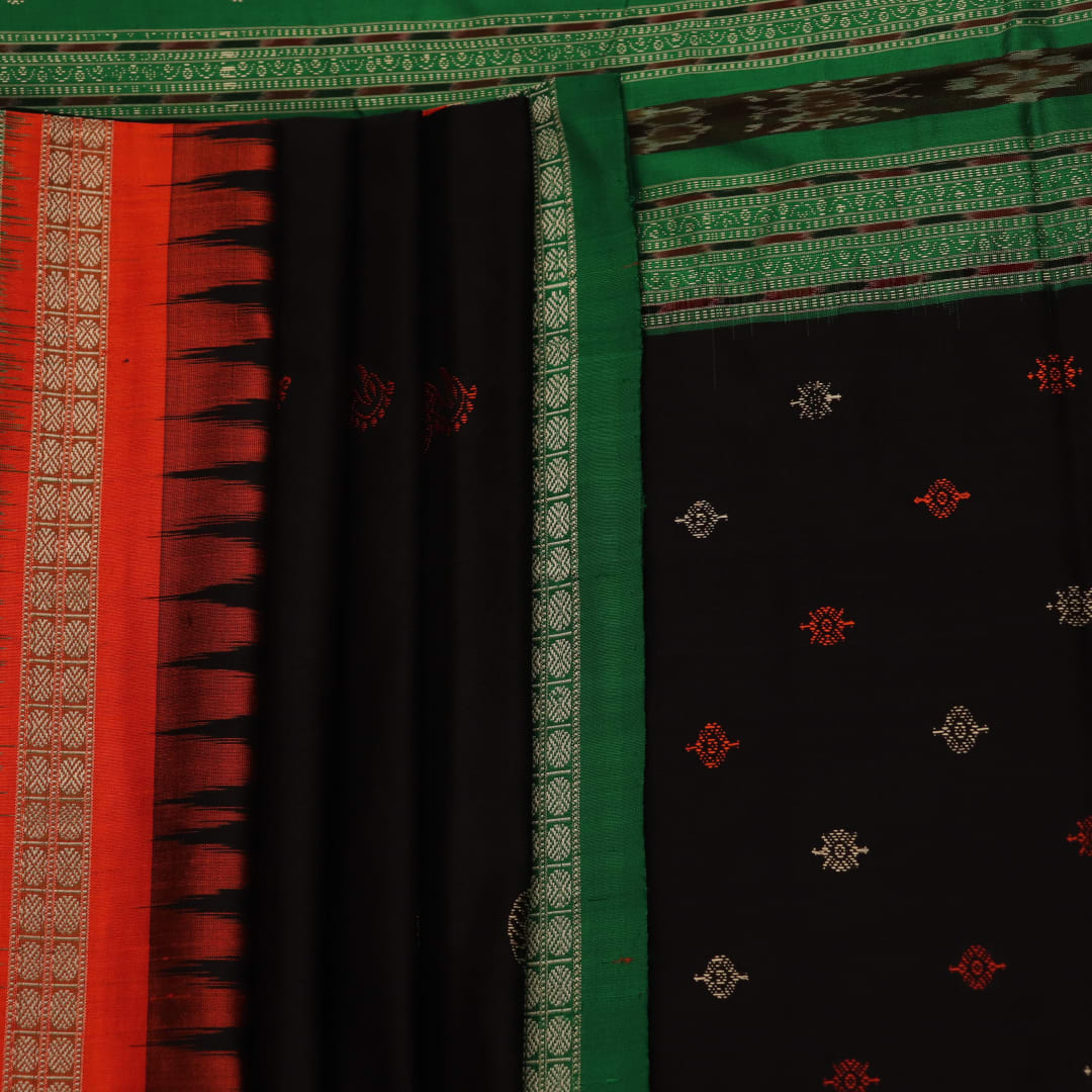 Close-up view of black silk Bomkai saree fabric showcasing its intricate butta pattern.