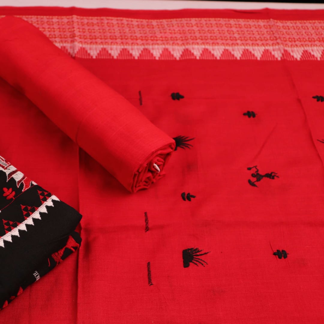 Close-up view of black and red cotton Sambalpuri dress material with doll pattern.