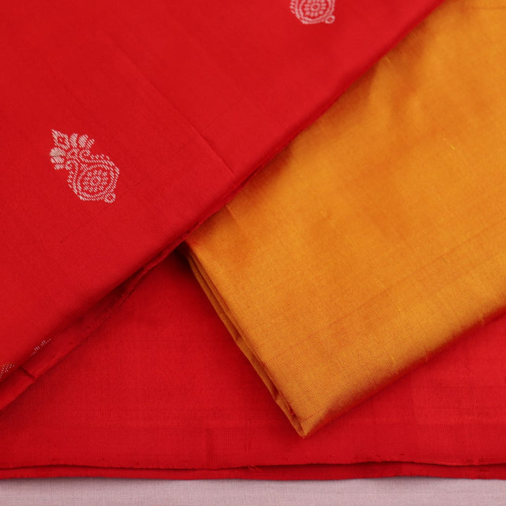 Red and yellow Bomkai silk dress material blouse piece with butta pattern.