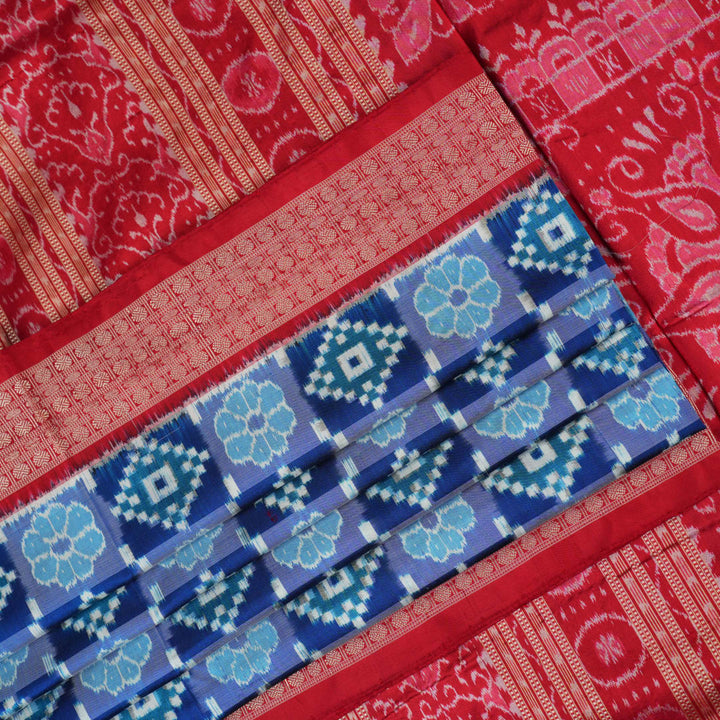 Close-up of the luxurious silk fabric texture and distinctive Sambalpuri ikat weave of the blue Pasapalli saree.