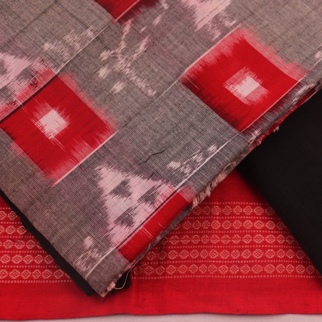 Detail of the grey and black Sambalpuri cotton dress material's blouse piece with motifs.
