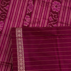 Close-up of plain cream and magenta Sambalpuri Silk Saree fabric texture.