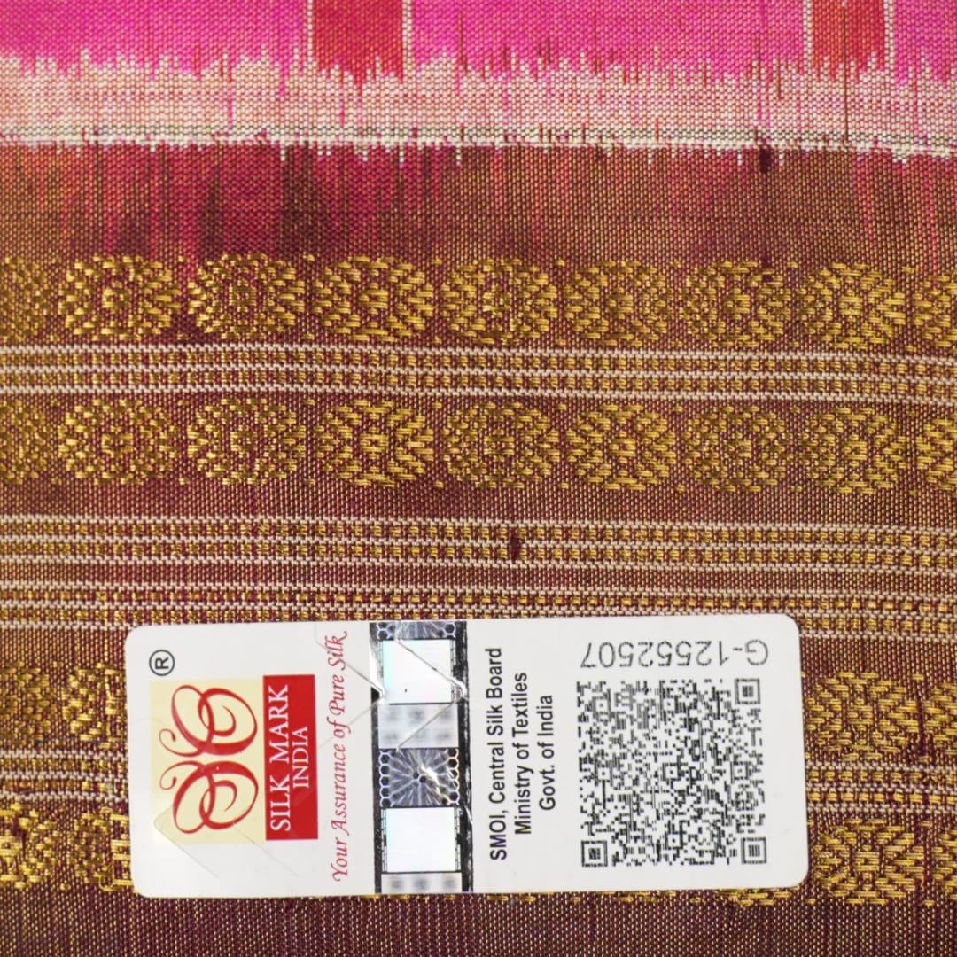 Close-up of Sambalpuri silk fabric texture, highlighting the fine weave in pink and maroon with delicate tissue motifs.