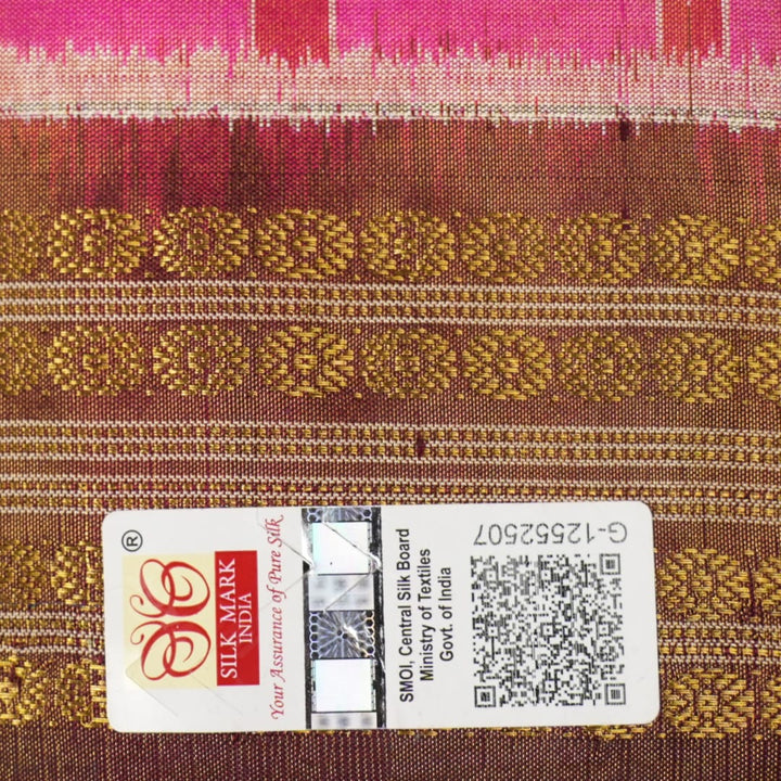Close-up of Sambalpuri silk fabric texture, highlighting the fine weave in pink and maroon with delicate tissue motifs.