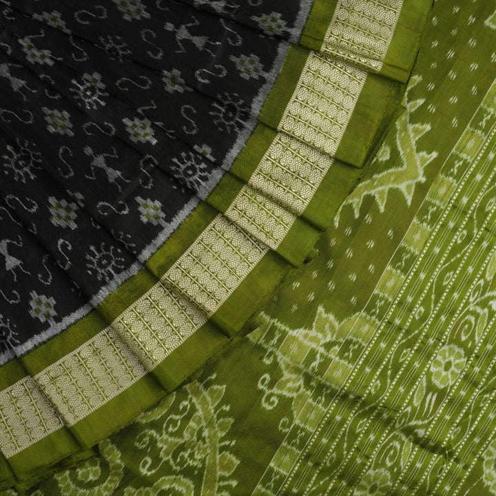 Close-up of the luxurious black and green Sambalpuri silk fabric texture and weave.