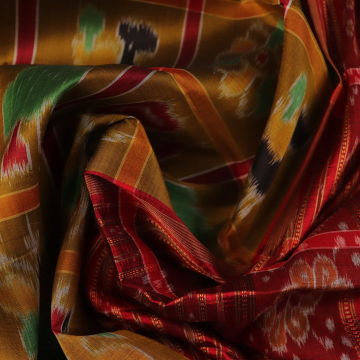 Green Khandua silk saree styled and draped to showcase the Nabakothi pattern, a traditional handloom saree.