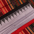 Close-up of grey and red Sambalpuri Silk saree fabric texture, highlighting butta pattern weave.