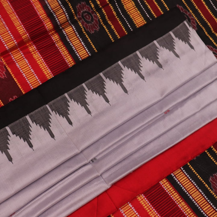Close-up of grey and red Sambalpuri Silk saree fabric texture, highlighting butta pattern weave.