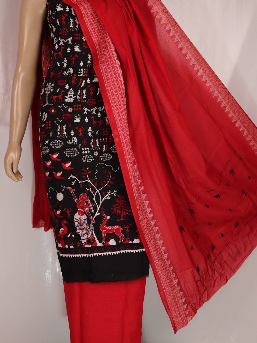 Close-up view of black and red cotton Sambalpuri dress material with doll pattern.