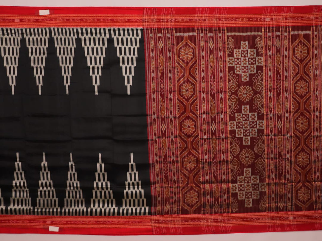 Khandua silk saree in black with red motifs, draped in a traditional style