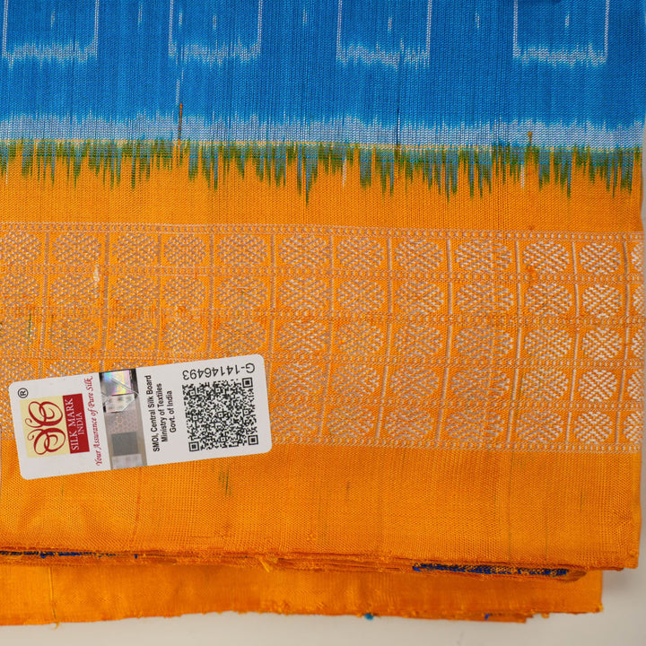 Close-up of the luxurious Sambalpuri silk fabric, highlighting its rich texture and handloom weave in blue and yellow.