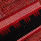 Close-up of black and red silk Sambalpuri saree fabric showcasing intricate motifs