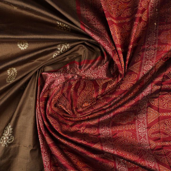 Close-up of Bomkai Silk Saree fabric, highlighting its luxurious brown silk texture and intricate weave.