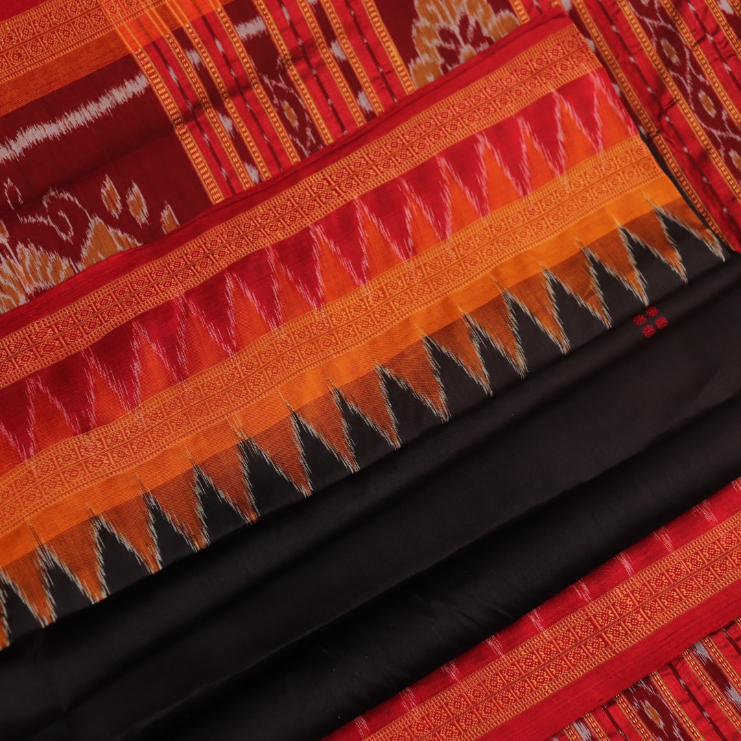 Black Khandua silk saree styled; showcases the drape and overall appearance, highlighting the red butta pattern.