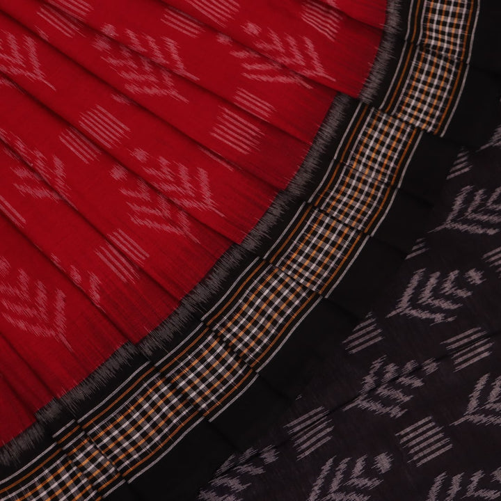 Red and black Sambalpuri cotton saree with motifs, elegantly draped to showcase its style and design.