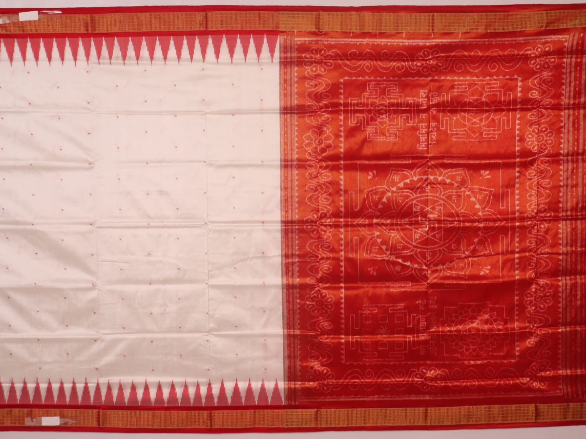 Close-up of white and red silk Bomkai saree fabric texture with butta pattern.
