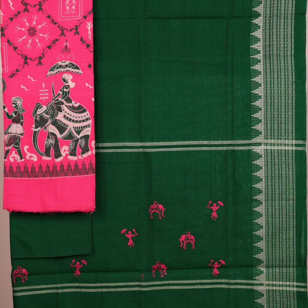 Close-up of the green and pink fabric texture of a Sambalpuri cotton dress material, featuring a repeating doll pattern.