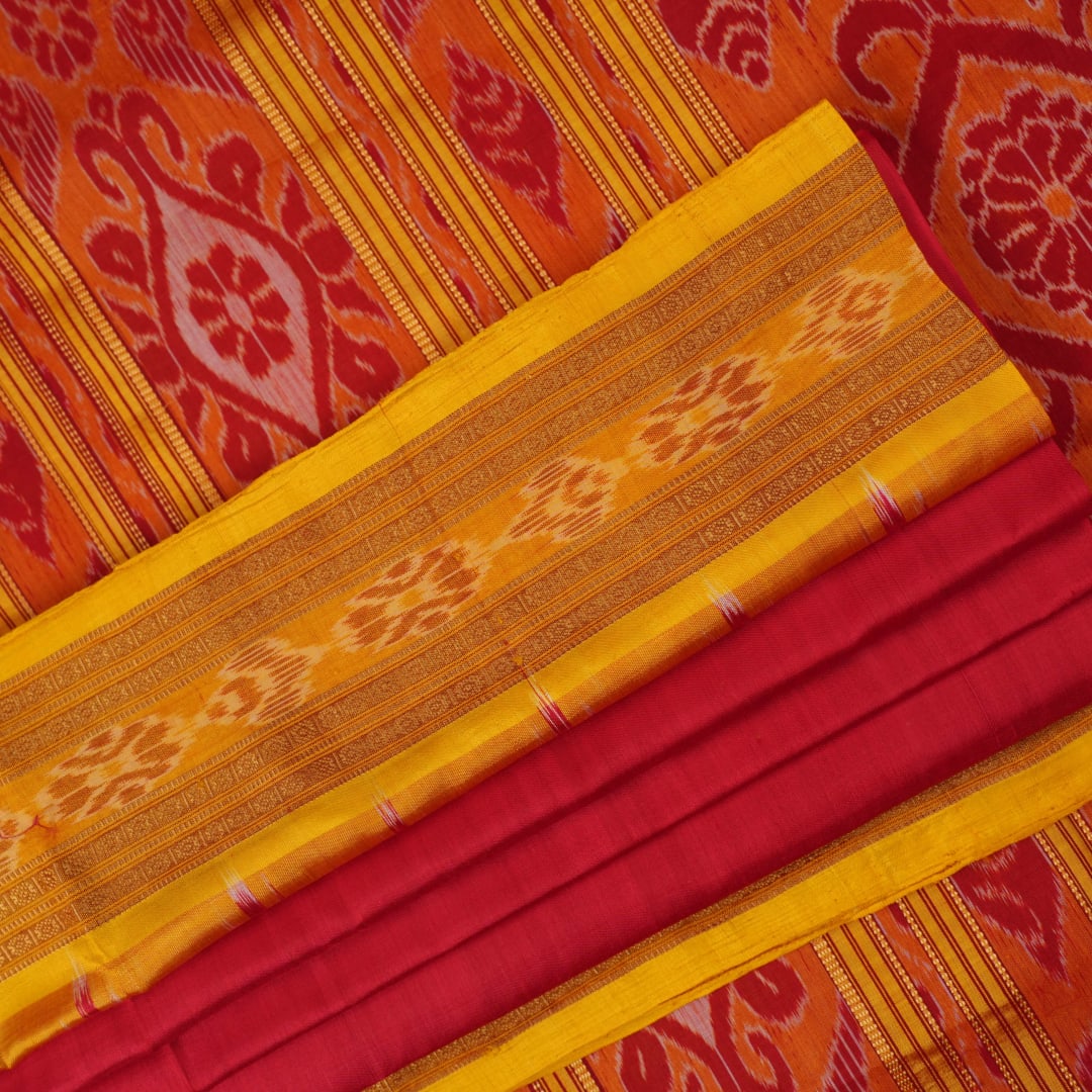 Model draped in a red and yellow Khandua silk saree with butta patterns for a traditional look.