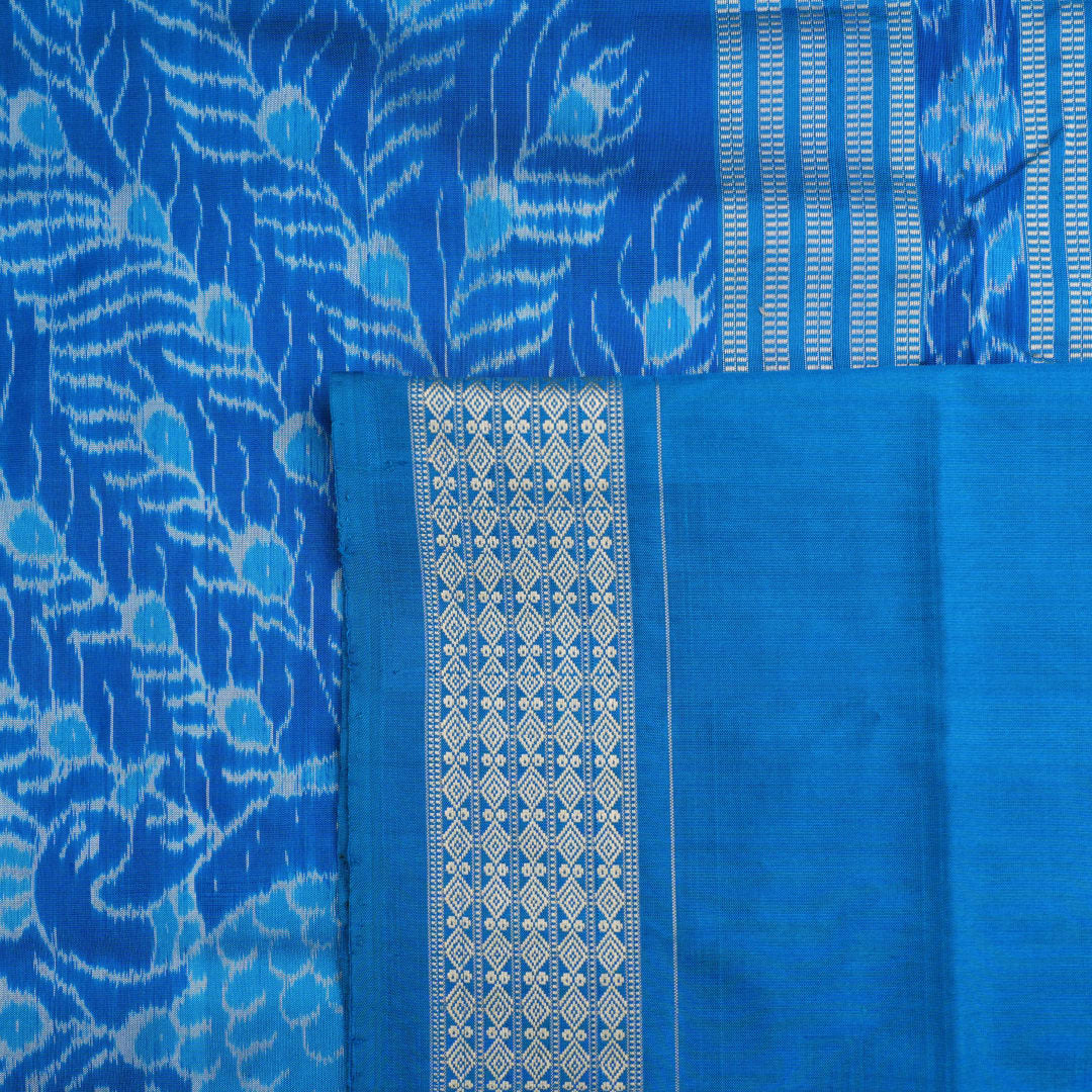 Close-up of the multi-color blue Sambalpuri silk saree fabric texture, highlighting intricate weave.