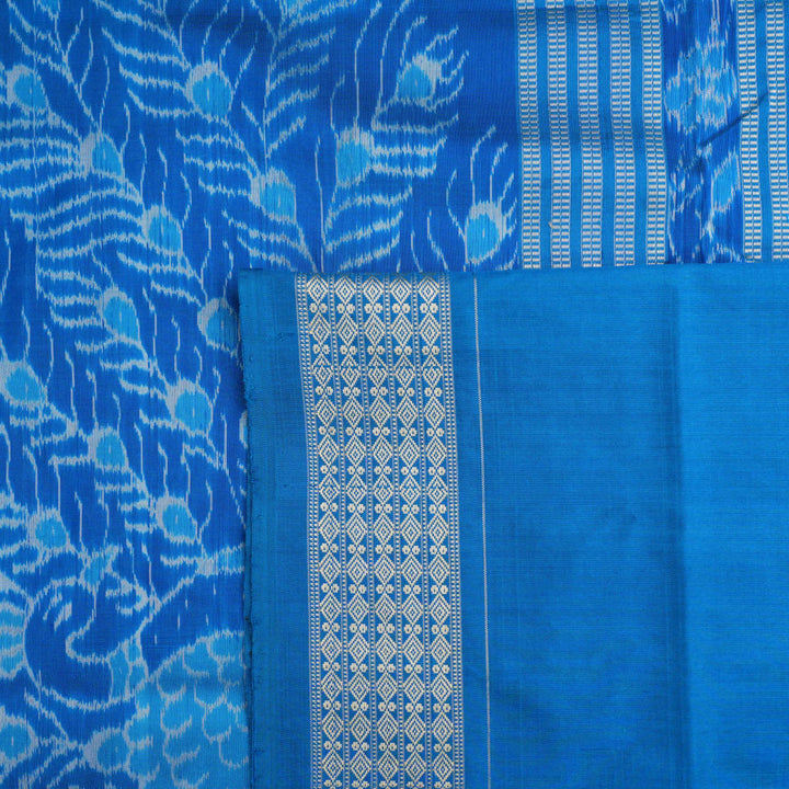 Close-up of the multi-color blue Sambalpuri silk saree fabric texture, highlighting intricate weave.