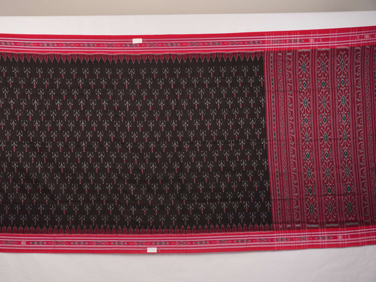 Model draped in a black and red Sambalpuri cotton saree showing traditional Odisha handloom styling.