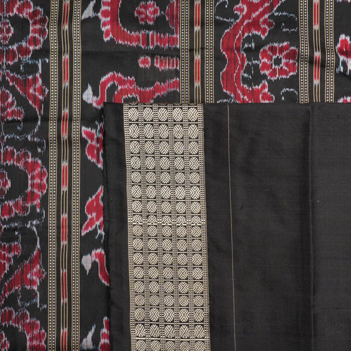 Close-up of the luxurious silk fabric texture and handloom weave of the grey and black Sambalpuri saree.